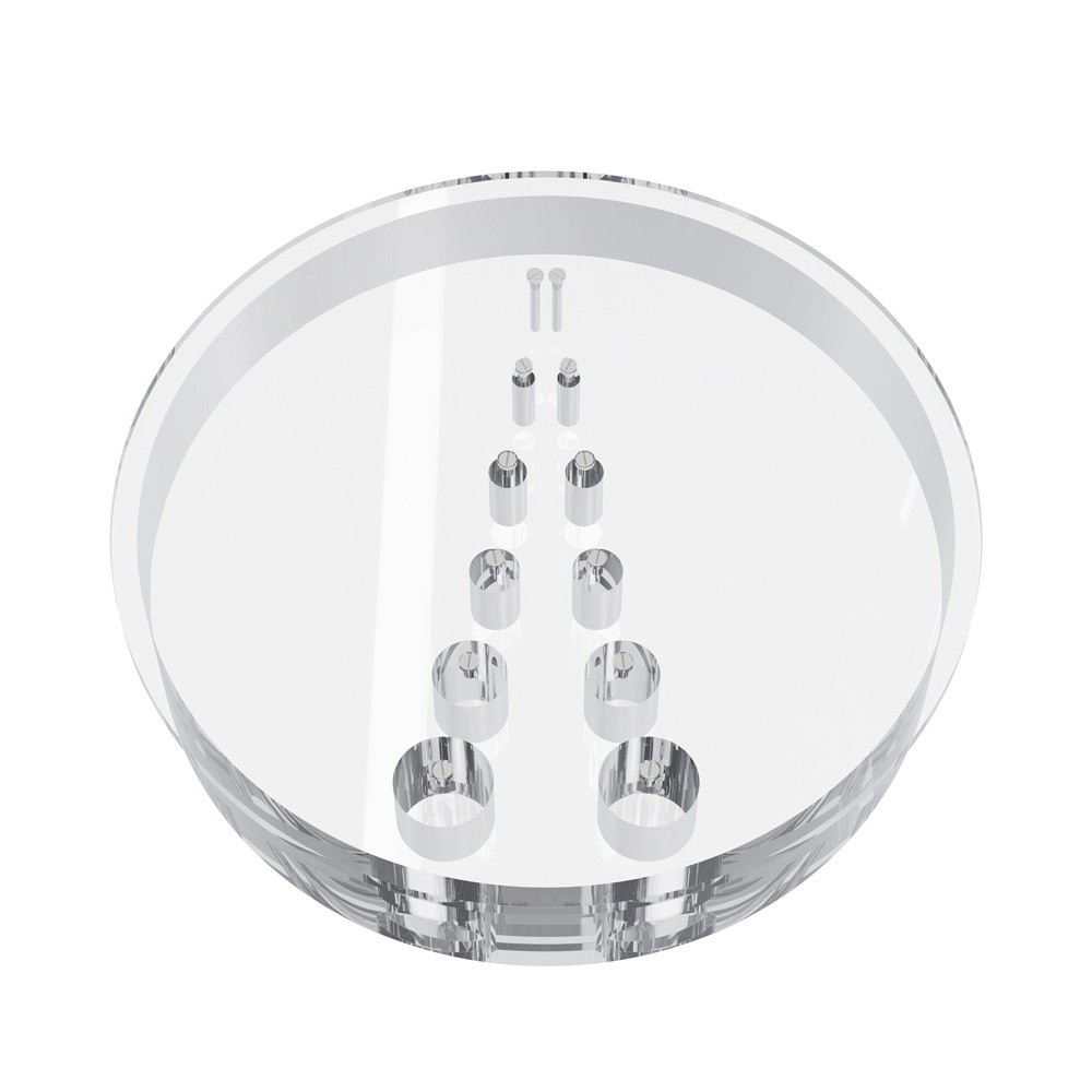 A transparent thick plastic disc with two rows of sealable, cylindrical cavities of different diameters.